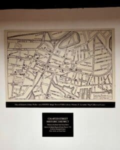 A historic map of Salem Massachusetts by Sidney Perley, dated between 1858-1928, displayed alongside an informational plaque about the Charter Street Historic District.