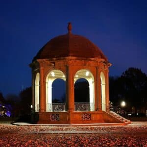 A beautifully lit gazebo at night in Salem Common, with its lights casting a warm glow against the dark evening sky.