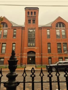 Phillips Elementary School in Salem, Massachusetts, a large historic brick building with a central tower and arched windows, known for its role in the film "Hocus Pocus."
