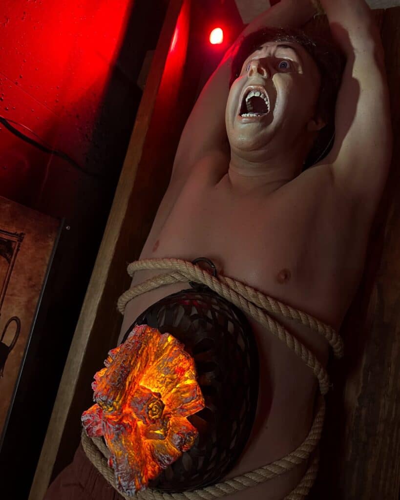  A mannequin tied down with a simulated rat cage containing glowing embers on their torso, part of the rat torture exhibit at the Salem Museum of Torture in Salem, Massachusetts.