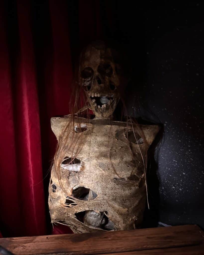 A skeletal figure with decayed features and holes in the torso on display at the Salem Museum of Torture in Salem, Massachusetts.