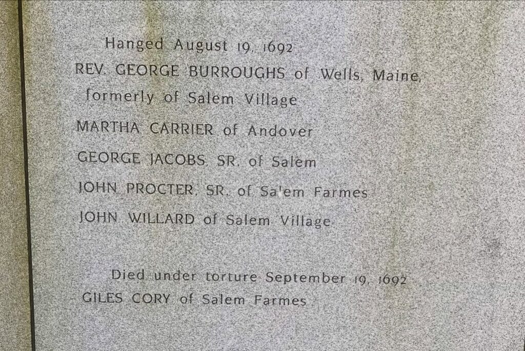 Stone memorial engraving in Salem honoring Rev. George Burroughs, Martha Carrier, George Jacobs Sr., John Procter Sr., John Willard, and Giles Cory, who died during the Salem witch trials of 1692.