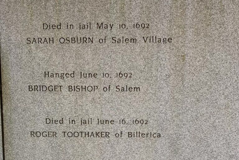An engraved stone at a Salem memorial commemorating Sarah Osburn, Bridget Bishop, and Roger Toothaker, victims of the Salem witch trials in 1692.