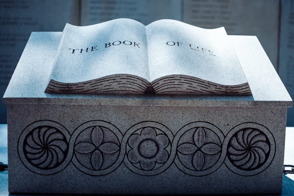 Close-up of "The Book of Life" sculpture at the Salem Village Witchcraft Memorial, featuring intricate carvings and a representation of a stone book.