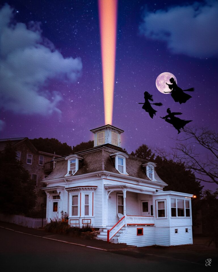 The Hocus Pocus house in Salem, Massachusetts, illuminated by a magical beam of light shooting into the night sky, with three silhouetted witches flying against a backdrop of a full moon and starry sky.